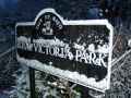 Snow settling on a Royal Victoria Park sign.